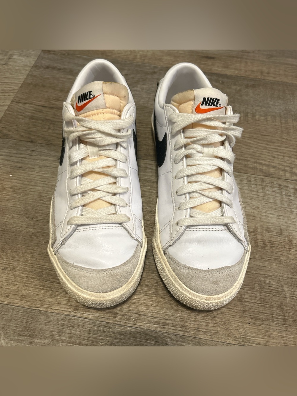 Nike White Leather Sneakers with Black Swoosh and Orange Tongue Logo